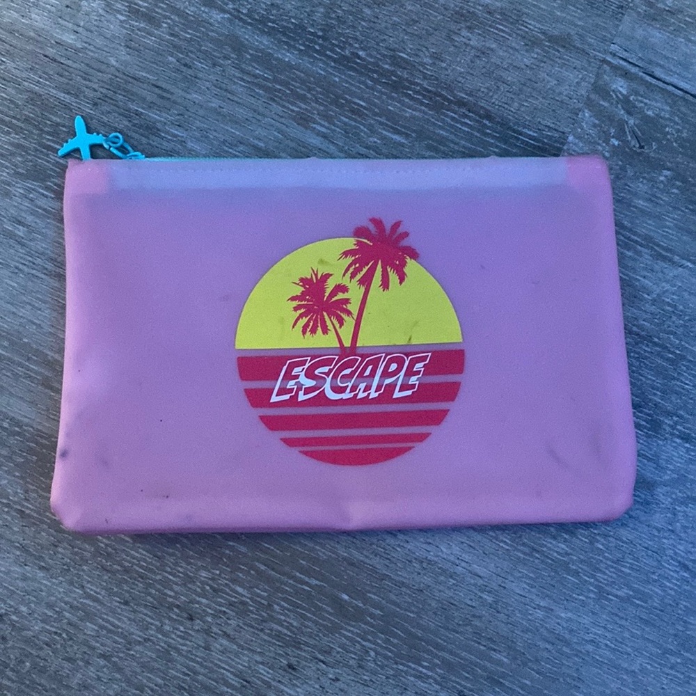 This is a little pink makeup bag. The brand is IPSY.